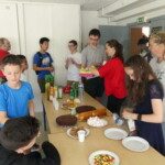 Enfants et adolescents se servant au buffet lors du goûter de fin de saison du club.